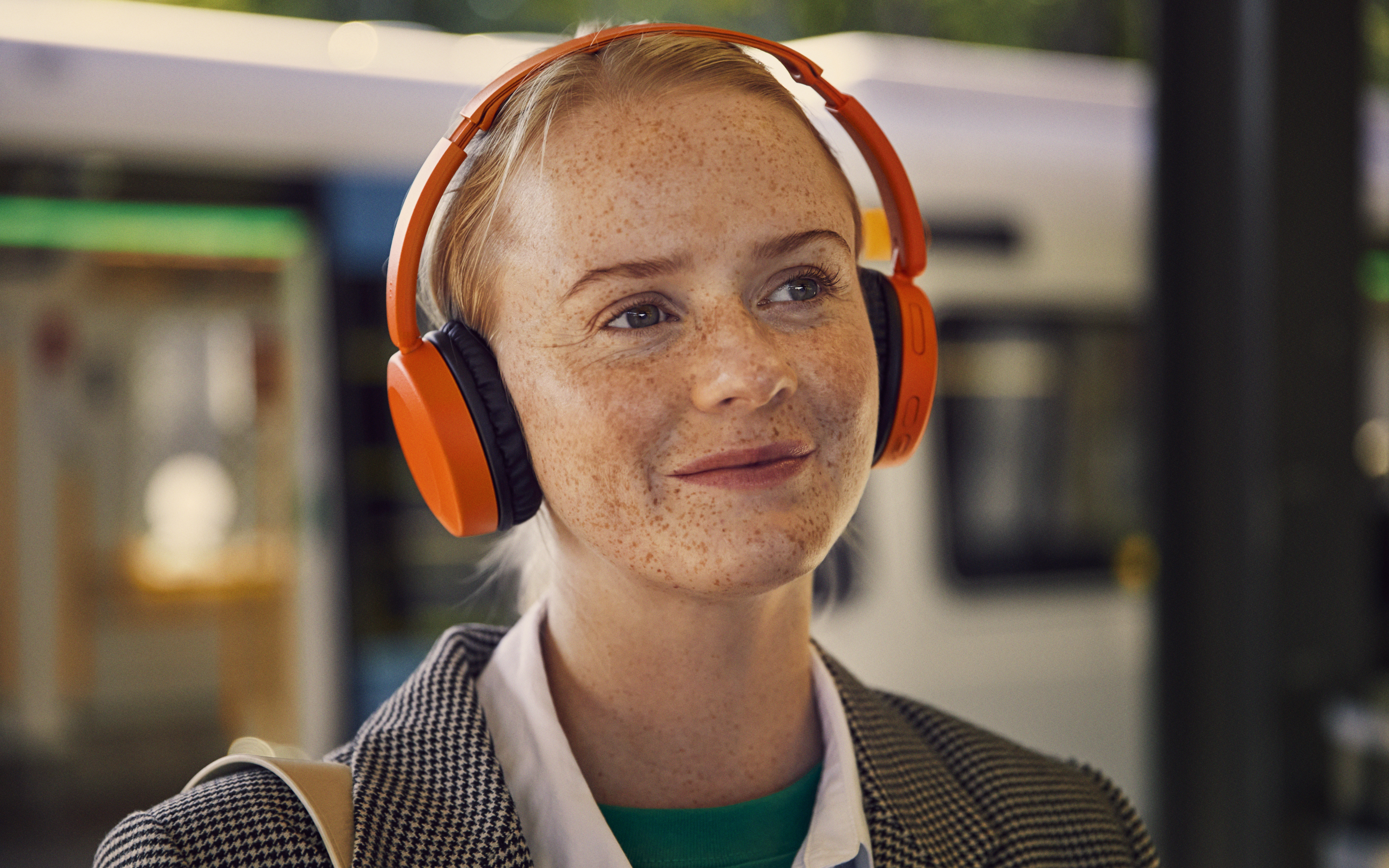 A woman smiling while listening to audiobook